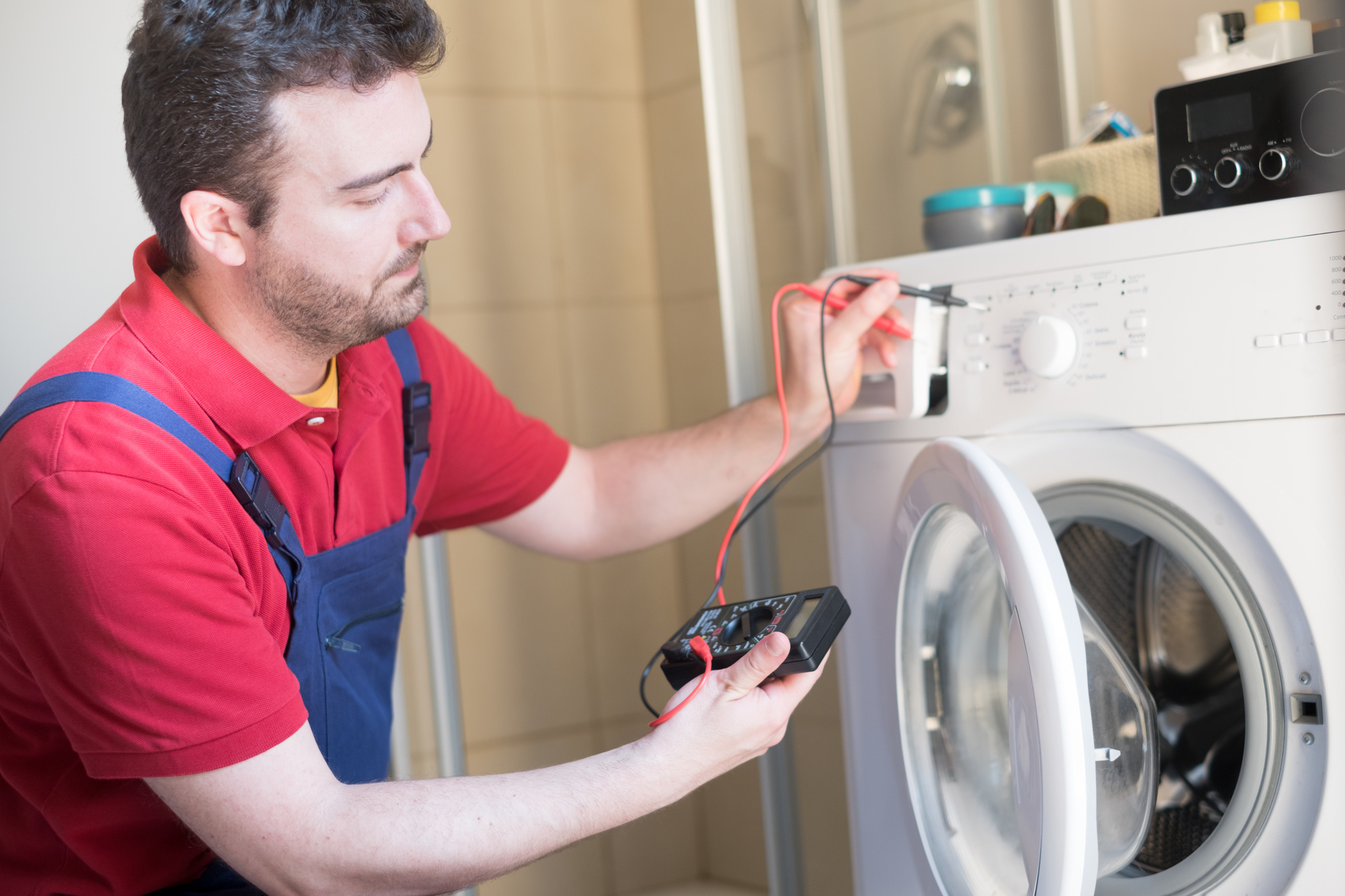 Worker repairing the washing machine in the bathroom shamsmartrepair